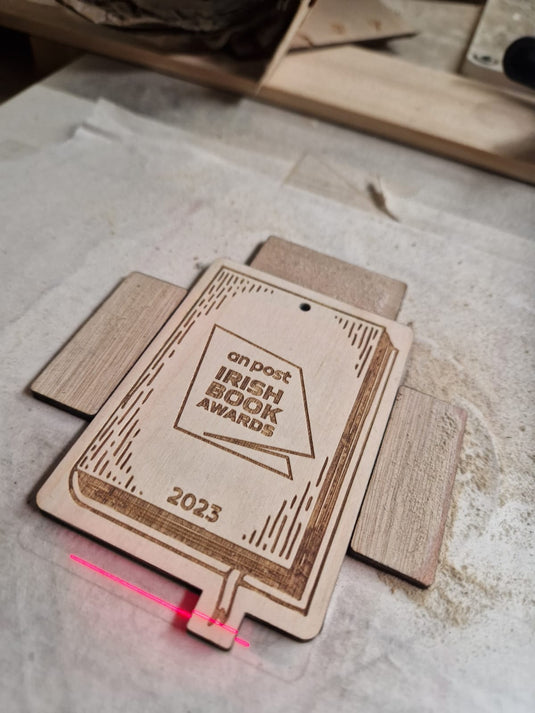 Stack of bespoke engraved wooden tags for An Post Irish Book Awards 2023